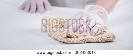 Young Woman Housewife Is Cleaning, Wiping Down Home Table Surface To Stop The Spread Of Infection Wi