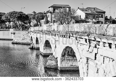 View of Rimini with ancient Bridge of Tiberius (Ponte di Tiberio), Italy - Black and white italian urban view