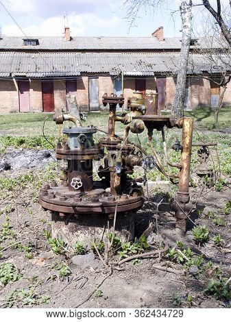 Ancient Tap Water. Abandoned And Rusty, Which Was Used To Pump Water.