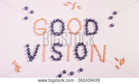 Vitamins And Supplements For Healthy Eyes On Pink Background. How To Maintain Good Vision Concept. B