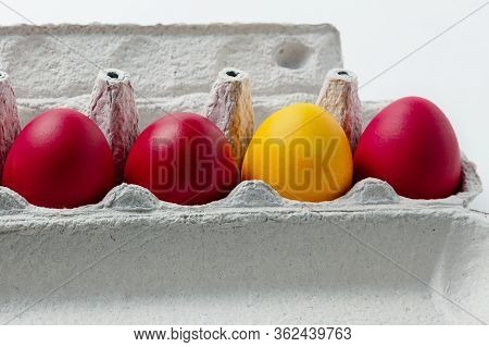 One Yellow Egg In A Row Of Red Easter Eggs In A Cardboard Box. Symbol Of Faith Tolerance And Otherne