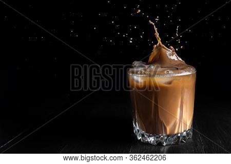 Splash Of Ice Coffee Drink On A Brown Background. Cold Beverage Wave. Close-up Design Liquor Milk, C