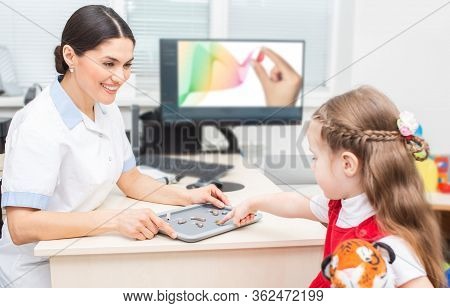 Hearing Solution For Child. Audiologist Selecting A Hearing Aid For A Little Girl. Child Needs Good 