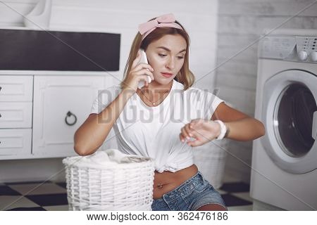 Woman In A Bathroom Near Wash Mashine