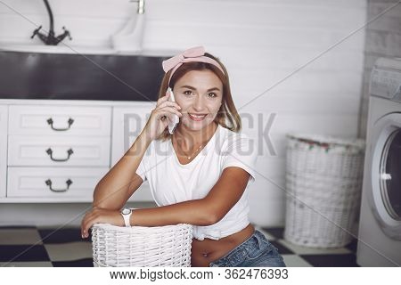 Woman In A Bathroom Near Wash Mashine