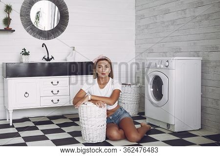Woman In A Bathroom Near Wash Mashine