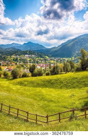 Stunning Alpine Landscape With Green Fields And Piatra Craiului Mountains In Dambovicioara Commune. 