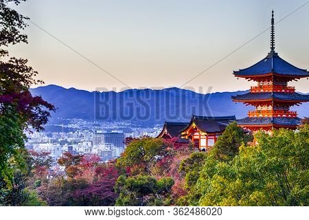 Japanese Heritage. Renowned Kiyomizu-dera Temple Pagoda Against Kyoto Skyline  And Traditional Red M