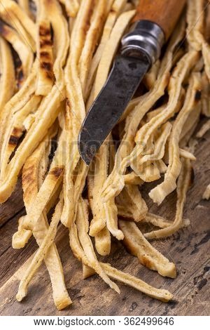 Stripes Of Sliced Pancake On Wood Wiht Knife
