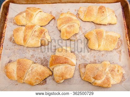 Pan Of Apple Pastry Pop Overs, Fresh From The Oven On A Cookie Sheet And Parchment Paper.  These Pas