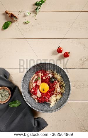 Red carbonara La Classic in gray bowl. Spaghetti with guanciale slices, egg, Parmesan and Pecorino Romano close up. Delicious delicatessen, noodles, served restaurant meal, tasty pasta