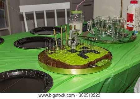 Close Up View Of Minecraft Theme For 5 Years Old Birthday Party. Black Plates And Hand Made Cake On 