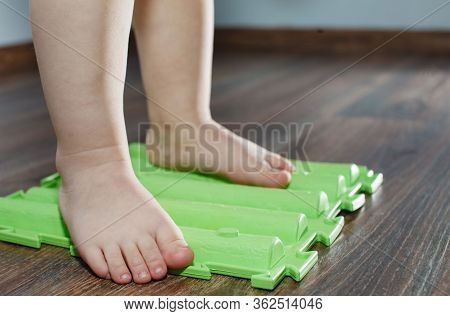 Child On Massage Mat Doing Exercises For Flatfoot Prevention