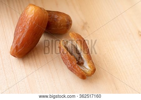 A Few Of Dried Sweet Deglet Nour Date Fruites On Wooden Table.organic Vegetarian Food