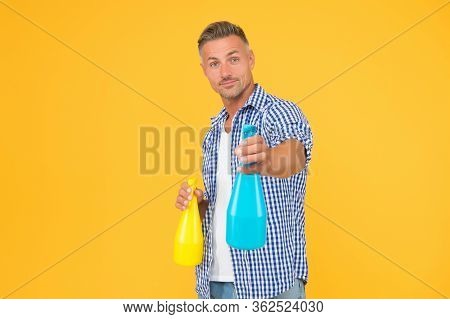 Make Your House Clean. Handsome Guy Hold Spray Bottles. Disinfectant Cleaners And Sprays. Clean Habi