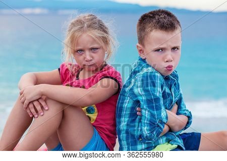 Upset Siblings Boy And Girl Sulking Sitting With Arms Crossed Back To Back, Not Talking, Kids Brothe