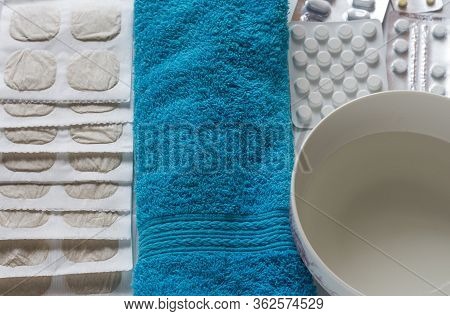 Mustard Sheets With Medicine And A Thermometer For Treating Colds With A Blue Towel And Water Are Re