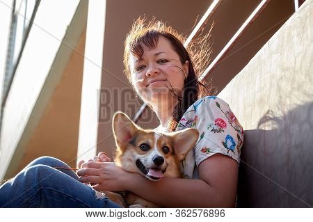 Pretty Funny Girl With Small Nice Dog Big Wall Of City House In A Sunny Day