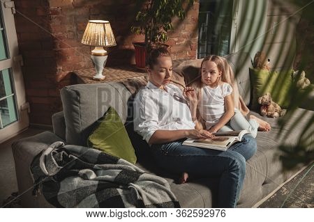Reading Book. Mother And Daughter During Self-insulation At Home While Quarantined, Family Time Cozy