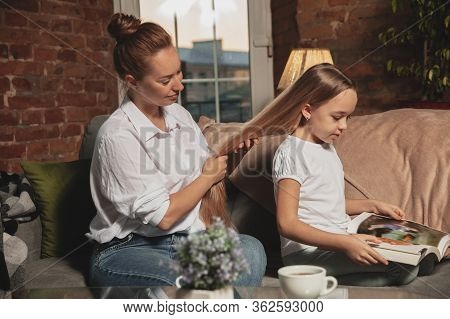 Hairdo, Hairstyle. Mother And Daughter During Self-insulation At Home While Quarantined, Family Time