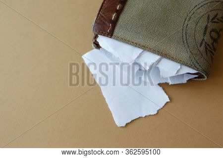 Empty Wallet With Pieces Of Paper Instead Of Money On A Light Monophonic Background, Top View. Bankr
