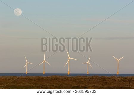 Sustainable Resource. Offshore Wind Farm Turbines Generating 24hr Electricity Night And Day. Uk Coas