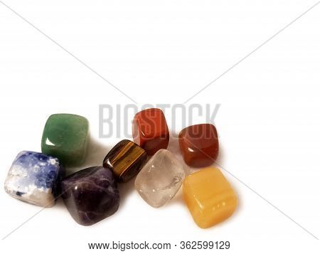 Chakra Stones - Natural Cubic Gems On A White Background: Jasper, Tigers Eye, Charoite, Lapis Lazuli