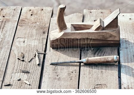 Wooden Background. Jointer Plane And Chisel With Sawdust Lie On The Village Table. Working Surface O