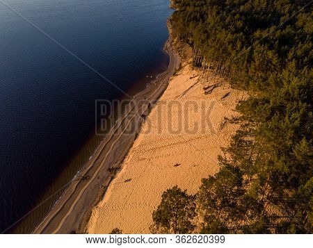 Beautiful Drone Areal Photography View Of Large Dune And Pine Forest Near River Lielupe. Photo Taken