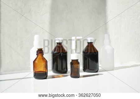 Various Medical Jars With Medicinal Potions On A White Background.