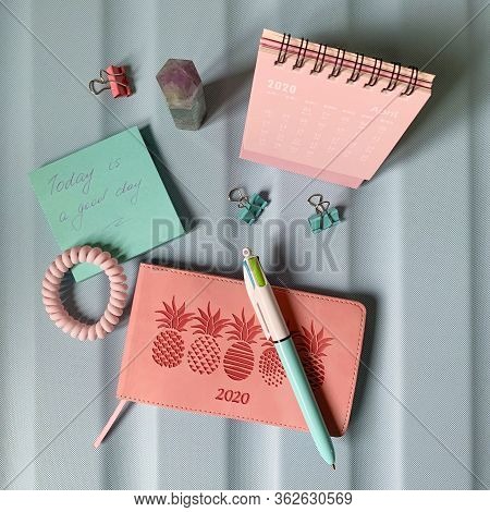 Flat Layout Of Blank Notepad With Pen And Stickers On Green Background