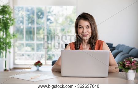 Beautiful Middle Age Asian Businesswoman Sitting At Desk And Using Laptop Notebook Computer In Apart