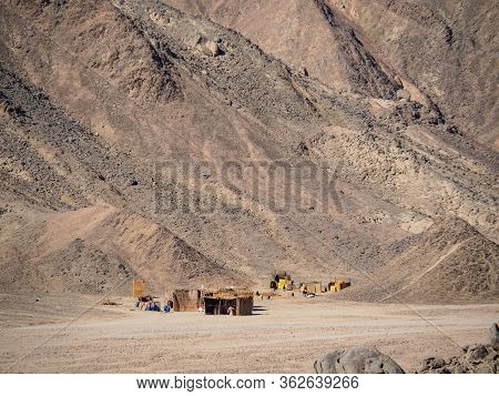 Bedouin Village Before High Hills, Long View. Egyptian Desrt In February. Grey Mountain Face In Dese