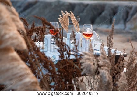 Wedding Decorations. Wedding Table For The Ceremony With Glasses Of Wine And Dried Flowers, Standing