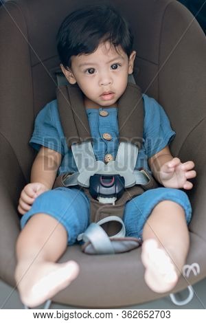 Adorable Baby Boy In Safety Car Seat. Portrait Happy Toddler Boy Sitting In The Car Seat. Boy Sittin
