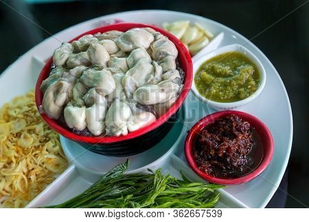 Oysters Food And Chili Sauce, Thai Food Is Oysters With Herbs Or Oyster Spicy Salad. Oysters With Ch