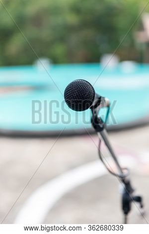 Microphone Outdoor Near Swimming Pools Soft And Blur Style For Background. Microphone Over The Abstr