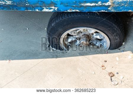 The Old Wheel Get Stuck In The Sands Of The Dunes In The Desert. Wheel In Countryside Landscape With