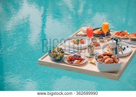Breakfast In Swimming Pool, Floating Breakfast In Tropical Resort. Table Relaxing In Calm Pool Water