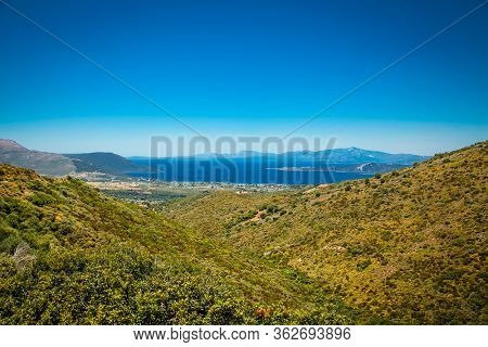 Panoramic view from above on the forests of Evia island  with the sea on the horizon on a sunny day. Evia . Greece. 