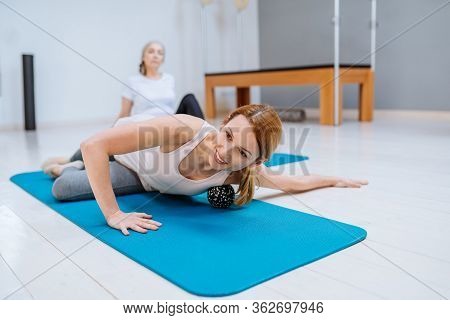 Female Doing Self-massage Technique Applying Tennis Balls For Back Pain Relief, Working Out On Fitne