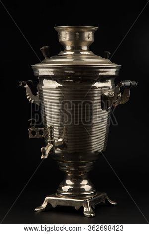 Old Russian Samovar On A Black Background