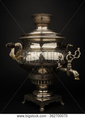 Old Russian Samovar On A Black Background