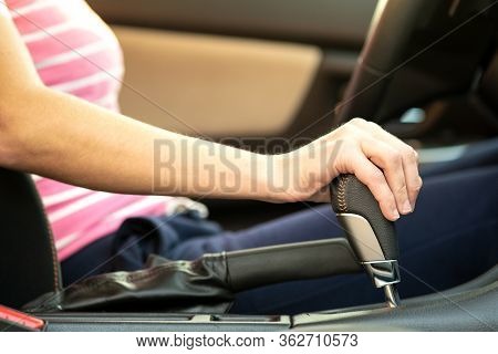 Close Up Of Woman Driver Holding Her Hand On Automatic Gear Shift Stick Driving As Car.