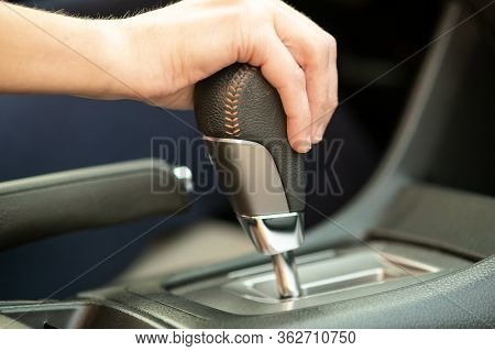 Close Up Of Woman Driver Holding Her Hand On Automatic Gear Shift Stick Driving As Car.