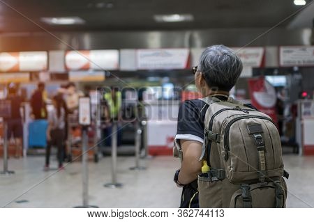 Behind Asian Senior Smart Woman Traveling Hipster With Backpack Standing Look Walkway At Airport Ter