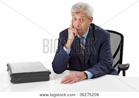 Attentive Senior Business Man Listens With Hand On Chin