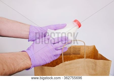 Wiping Down Grocery Packages After Receiving Home Delivery Wearing Gloves