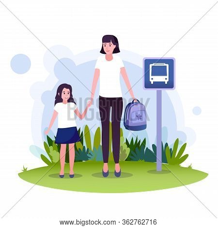 A Young Mother With Her Lovely Daughter Are Waiting For The School Bus At The Bus Station.
