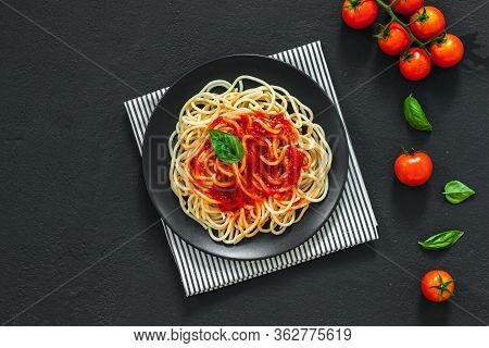 Сlassic Italian Spaghetti Pasta With Tomato Sauce And Basil On Plate On Dark Table. View From Above,